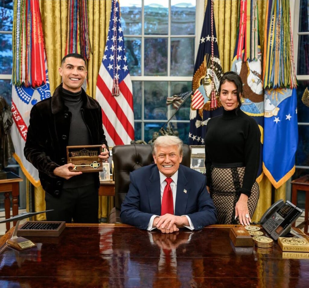 Cristiano Ronaldo presenting a gift to Donald Trump in the Oval Office, with Georgina Rodriguez.